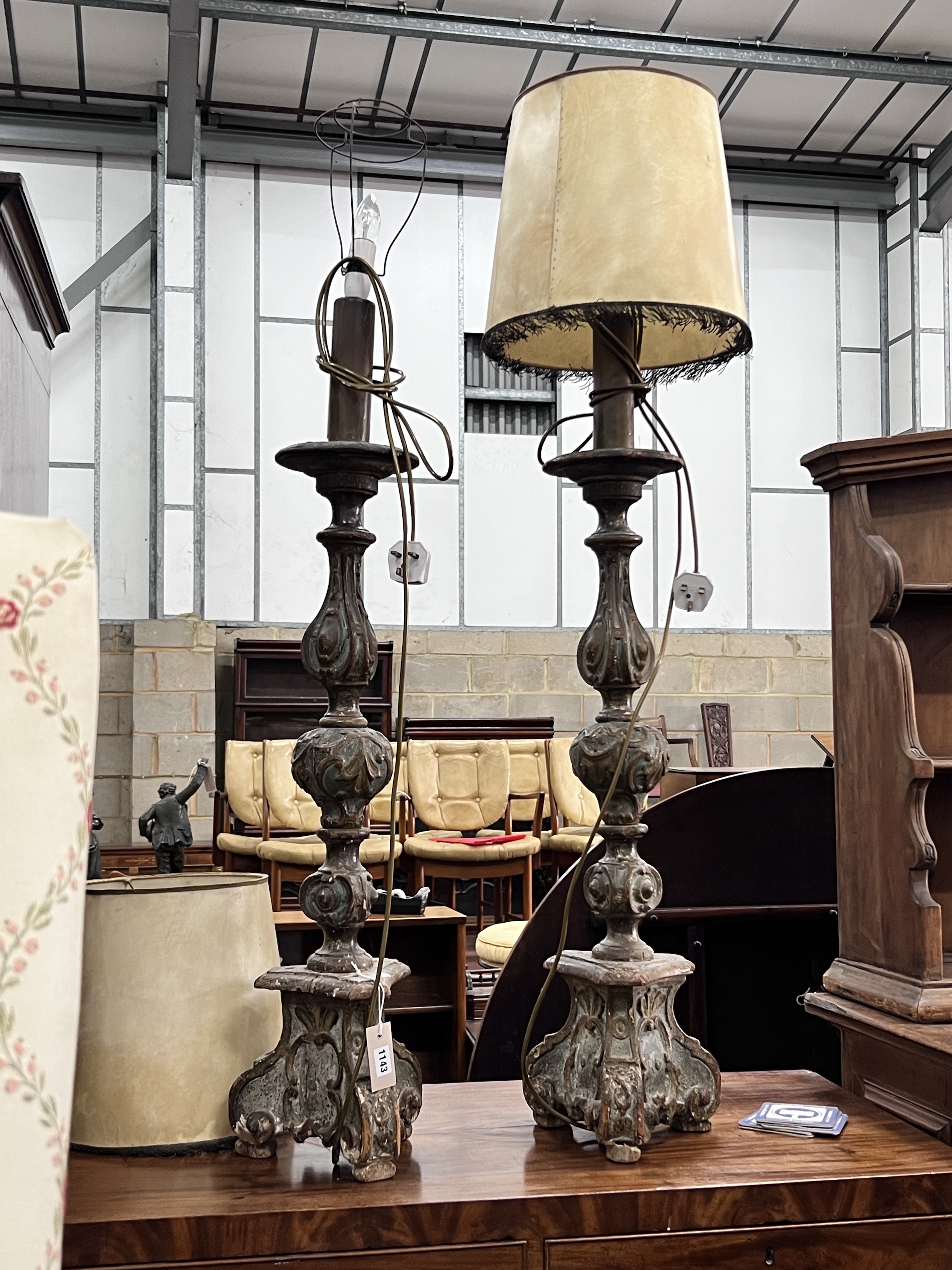 A pair of late 17th century Florentine carved and painted wood altar style pricket candlesticks (converted to lamps), 102cm